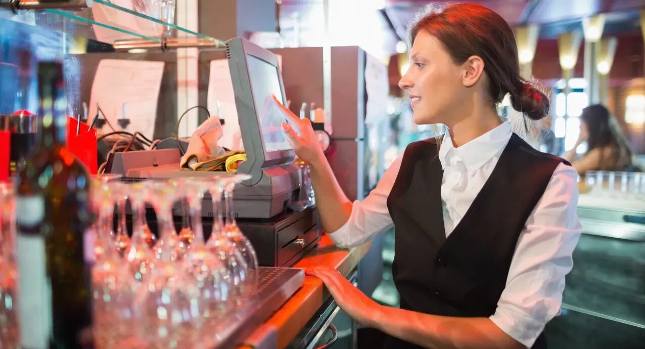 Bar staff working an EPOS touchscreen terminal